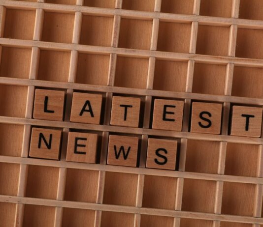 Канада следит за ситуацией после наводнений в Непале и Китае Wooden letter blocks spelling Latest News on a grid background, ideal for media themes.