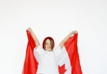 A child joyfully holding a Canadian flag, celebrating patriotism and freedom.