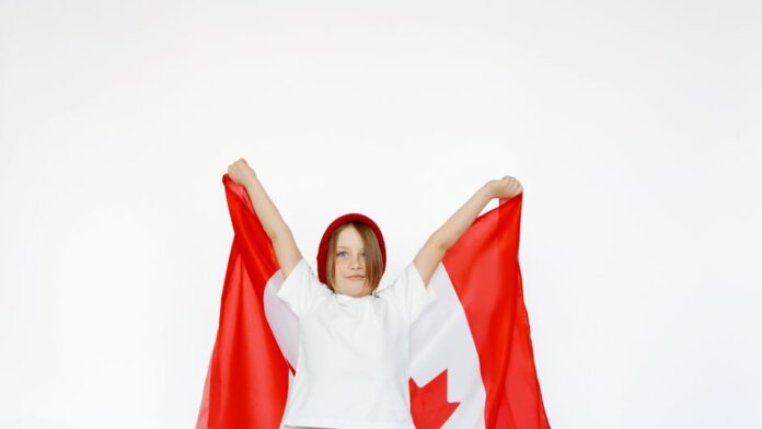 A child joyfully holding a Canadian flag, celebrating patriotism and freedom. A child joyfully holding a Canadian flag, celebrating patriotism and freedom.