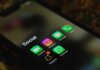 A close-up shot of smartphone displaying social media apps icons on screen.