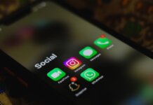 A close-up shot of smartphone displaying social media apps icons on screen.