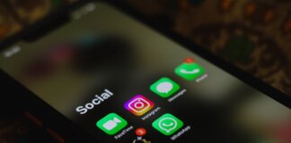A close-up shot of smartphone displaying social media apps icons on screen.