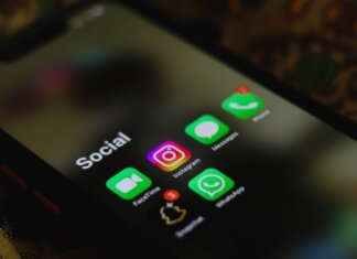A close-up shot of smartphone displaying social media apps icons on screen.