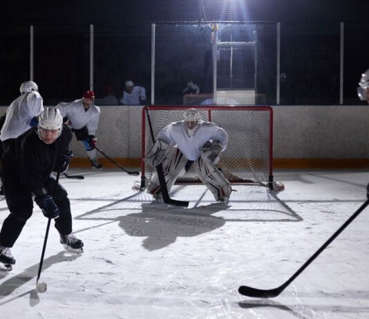 A dynamic moment captured during an ice hockey practice game in an indoor rink.