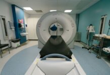 A high-tech MRI machine in a spacious hospital examination room, ready for medical scanning.