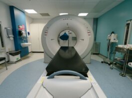A high-tech MRI machine in a spacious hospital examination room, ready for medical scanning.