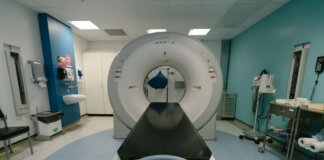 A high-tech MRI machine in a spacious hospital examination room, ready for medical scanning.