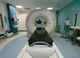 A high-tech MRI machine in a spacious hospital examination room, ready for medical scanning.