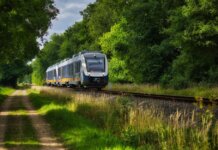 40 летних мест в Метро Ванкувере, куда легко добраться на транспорте A modern passenger train moving through a scenic, green countryside, emphasizing travel and transportation.