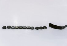 Выбор шести: собираем идеальный пакет матчей «Джетс» A row of hockey pucks and a stick on an ice rink, perfect for sports content.