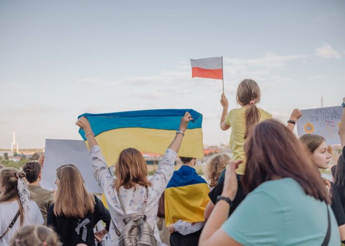 A vibrant demonstration in Szczecin, Poland featuring crowds waving Polish and Ukrainian flags in unity. A vibrant demonstration in Szczecin, Poland featuring crowds waving Polish and Ukrainian flags in unity.