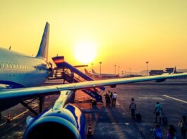 A vibrant image of passengers boarding an airplane at sunrise, highlighting air travel.