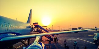 A vibrant image of passengers boarding an airplane at sunrise, highlighting air travel.
