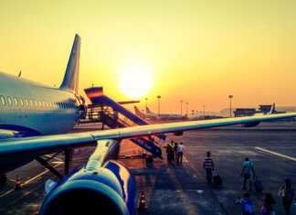 A vibrant image of passengers boarding an airplane at sunrise, highlighting air travel.