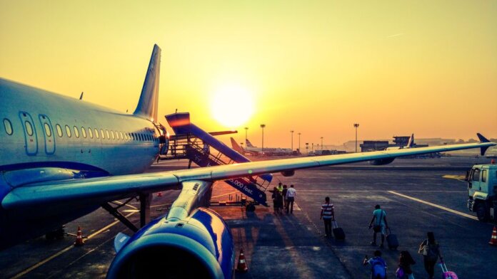 A vibrant image of passengers boarding an airplane at sunrise, highlighting air travel. A vibrant image of passengers boarding an airplane at sunrise, highlighting air travel.