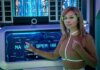 Умные очки Meta Ray-Ban Display поступили в продажу в Канаде: что нового A woman interacts with a futuristic touchscreen display in a technology-themed environment.