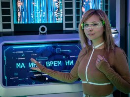 A woman interacts with a futuristic touchscreen display in a technology-themed environment.
