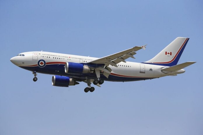 Airplane flying in clear blue sky with Canadian government livery. Airplane flying in clear blue sky with Canadian government livery.
