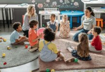 Children in circle time with teachers, engaging in a kindergarten classroom activity.