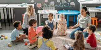 Children in circle time with teachers, engaging in a kindergarten classroom activity.