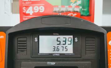 Close-up of a gas pump display showing price per liter and total volume during a transaction.