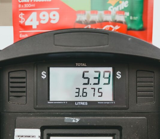 Close-up of a gas pump display showing price per liter and total volume during a transaction.