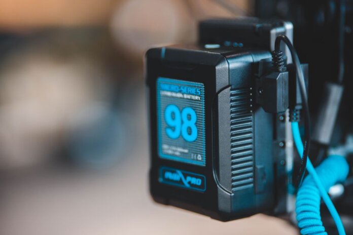 Close-up of a high-capacity portable battery with digital display showing 98 percent charge. Close-up of a high-capacity portable battery with digital display showing 98 percent charge.