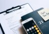 Close-up of income statement, calculator, and planner for financial planning.