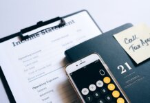 Close-up of income statement, calculator, and planner for financial planning.
