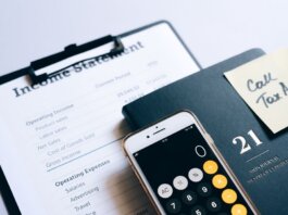 Close-up of income statement, calculator, and planner for financial planning.