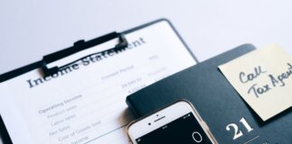 Close-up of income statement, calculator, and planner for financial planning.