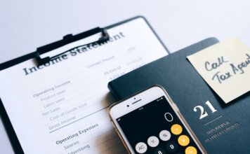 Close-up of income statement, calculator, and planner for financial planning.