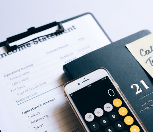 Close-up of income statement, calculator, and planner for financial planning.