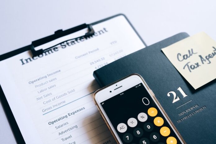 Close-up of income statement, calculator, and planner for financial planning. Close-up of income statement, calculator, and planner for financial planning.