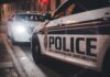 Close-up of Royal Newfoundland Constabulary police cars parked on a street at night.