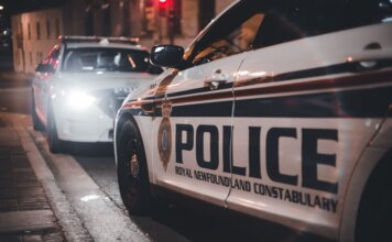 Close-up of Royal Newfoundland Constabulary police cars parked on a street at night.
