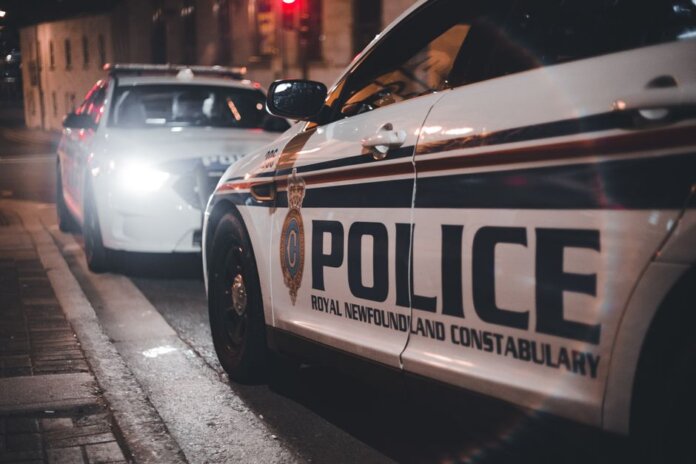 Close-up of Royal Newfoundland Constabulary police cars parked on a street at night. Close-up of Royal Newfoundland Constabulary police cars parked on a street at night.