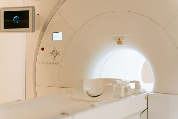Close-up view of a modern CT scanner in a healthcare facility. Close-up view of a modern CT scanner in a healthcare facility.