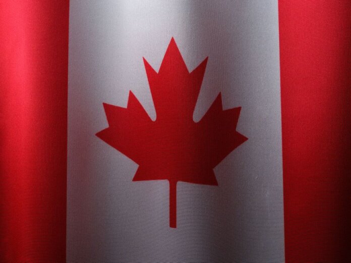 Close-up view of the Canadian flag with its iconic red maple leaf. Close-up view of the Canadian flag with its iconic red maple leaf.