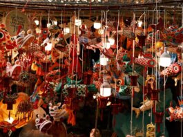 Colorful lanterns and decorations hang tightly in a bustling market for the Mid-Autumn Festival.