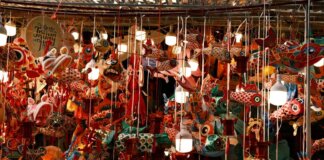 Colorful lanterns and decorations hang tightly in a bustling market for the Mid-Autumn Festival.