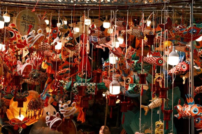 Colorful lanterns and decorations hang tightly in a bustling market for the Mid-Autumn Festival. Colorful lanterns and decorations hang tightly in a bustling market for the Mid-Autumn Festival.