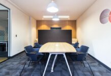 Contemporary conference room with stylish furniture and lighting, ideal for meetings.