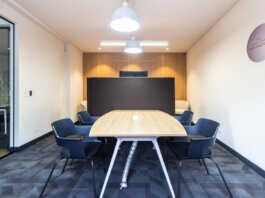 Contemporary conference room with stylish furniture and lighting, ideal for meetings.