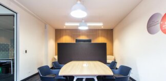 Contemporary conference room with stylish furniture and lighting, ideal for meetings.