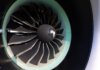 Detailed close-up of jet engine turbine blades showcasing engineering precision on an aircraft.