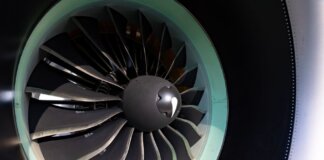 Detailed close-up of jet engine turbine blades showcasing engineering precision on an aircraft.