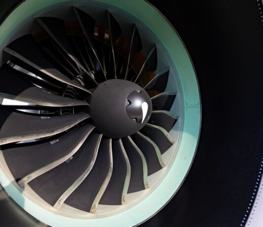 Detailed close-up of jet engine turbine blades showcasing engineering precision on an aircraft.