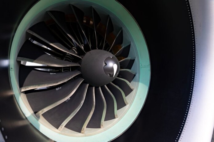 Detailed close-up of jet engine turbine blades showcasing engineering precision on an aircraft. Detailed close-up of jet engine turbine blades showcasing engineering precision on an aircraft.