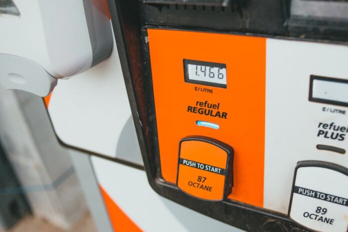 Detailed view of a gas pump showing price and octane level 87. Detailed view of a gas pump showing price and octane level 87.